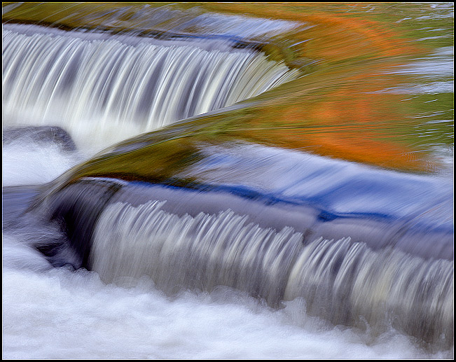 Z shaped rapids reflecting orange and blue, upstream from Bond Falls, Upper Michigan, Fall