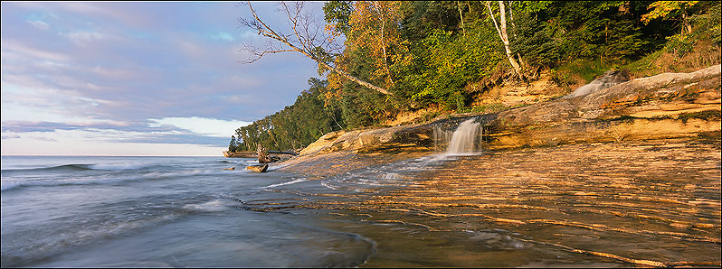 Panoramic photo of a \Pictured Rocks National Lakeshore Waterfall in Fall near Miner's Beach, Michigan